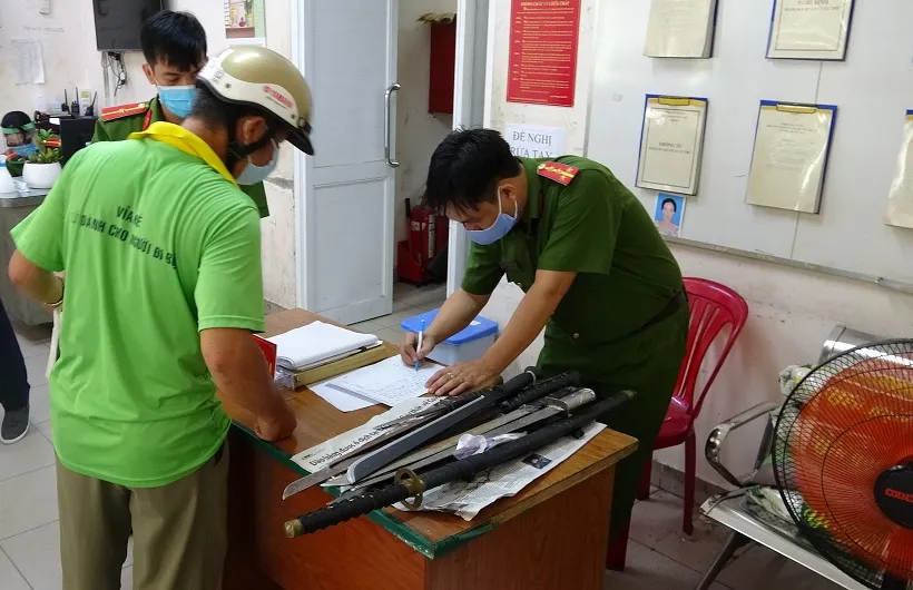 Người dân đến giao nộp vũ khí thô sơ. Ảnh: CA TPHCM