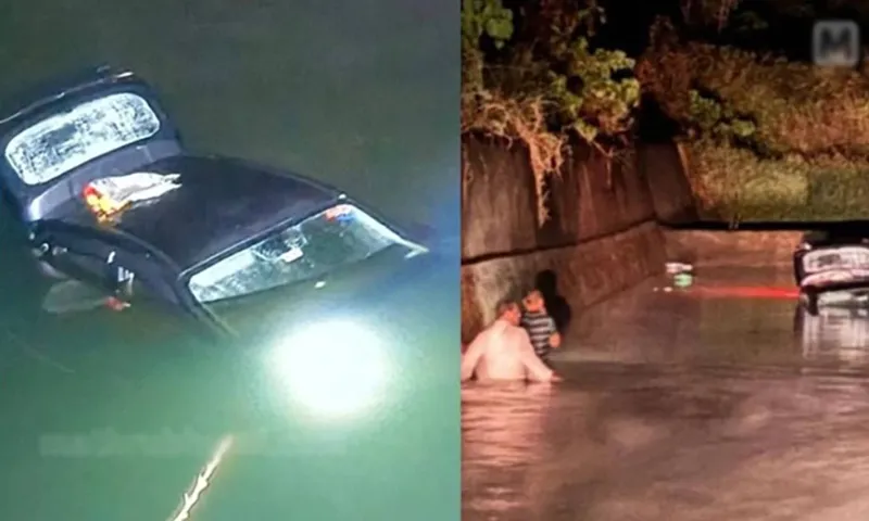 Ôtô chìm hơn một nửa dưới nước sau khi rơi xuống sông. Ảnh Mathrubhumi