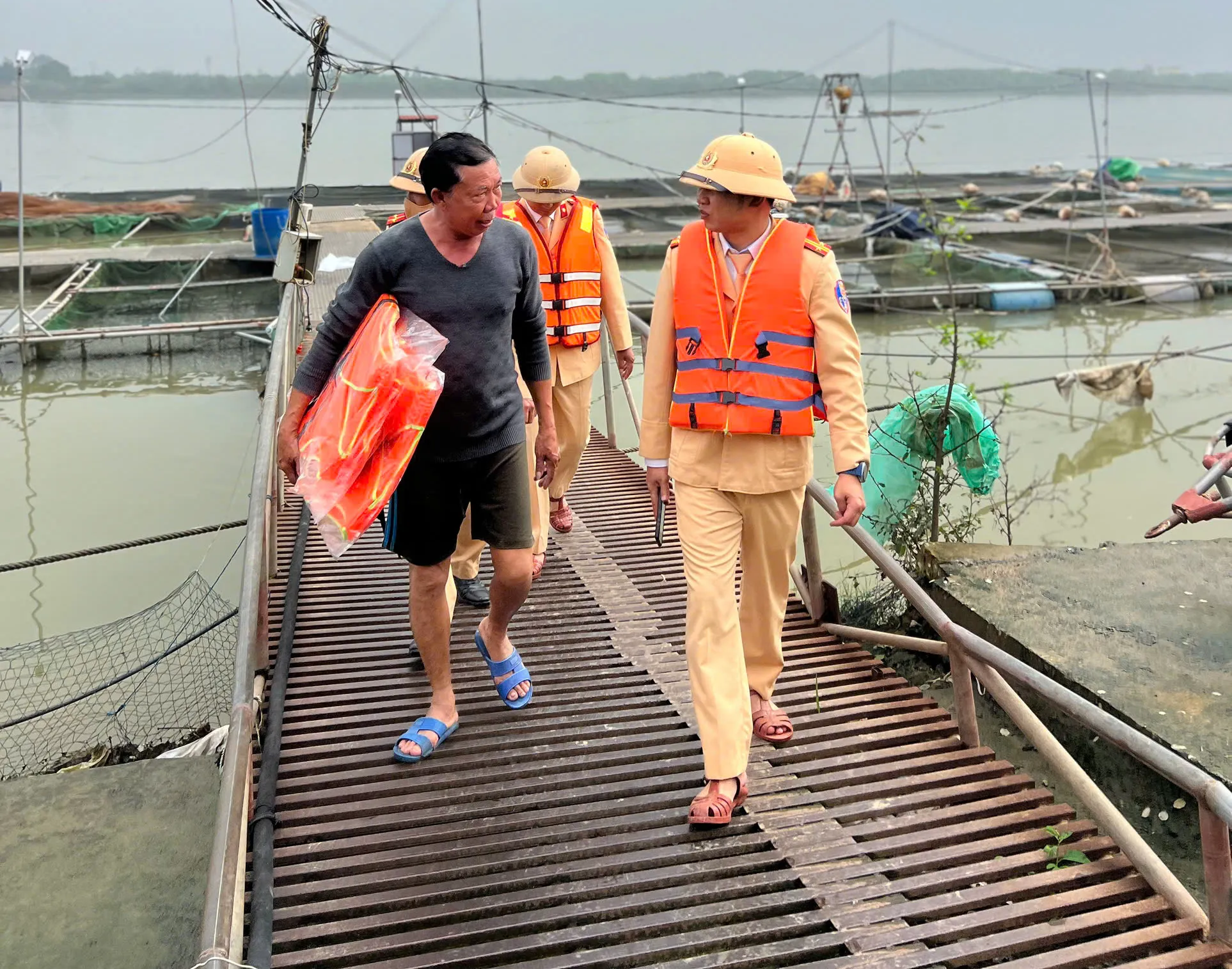 Lực lượng CSGT tặng áo phao cho các chủ bè nuôi trồng thủy sản