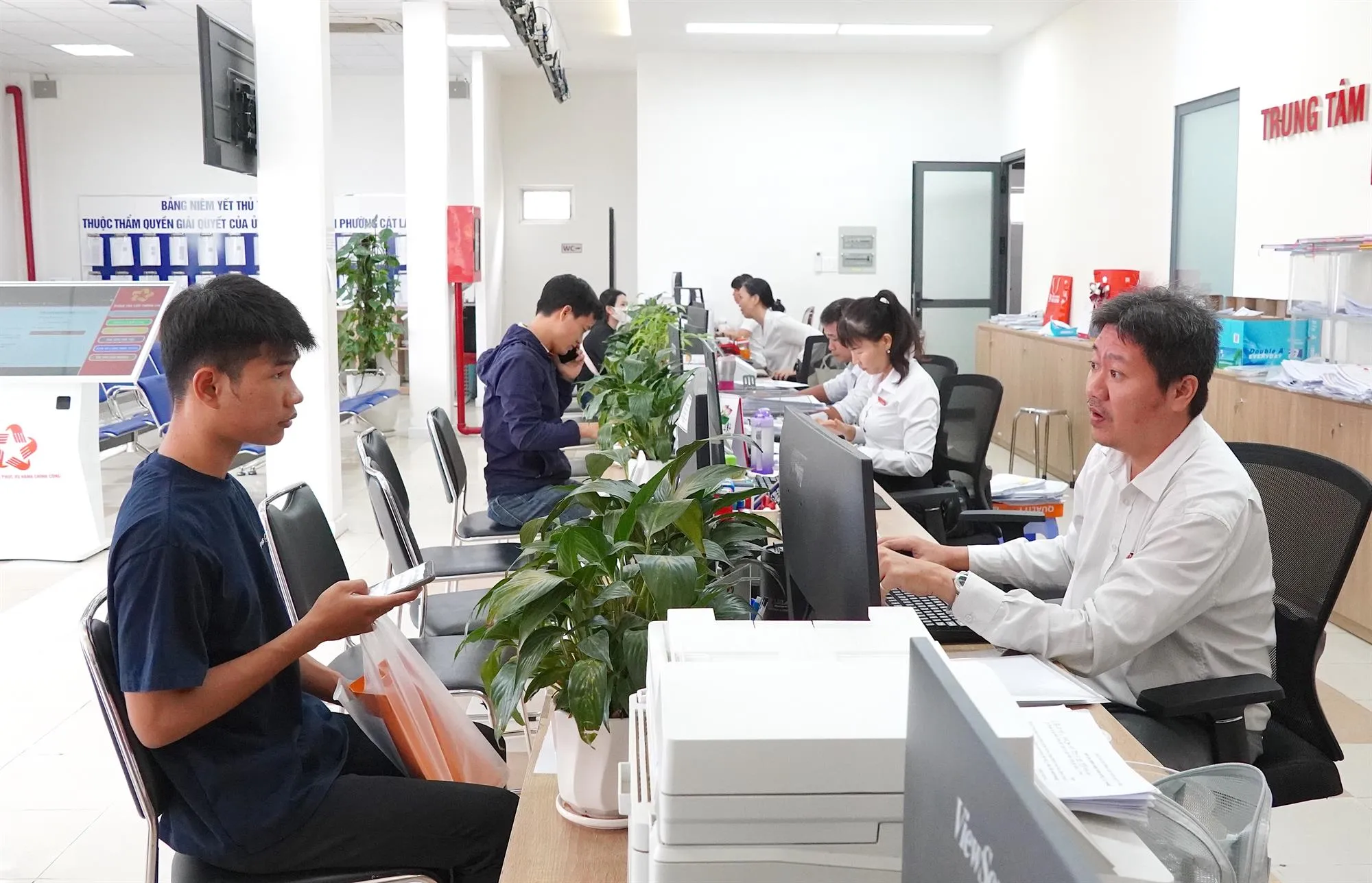 Chuyên viên Trung tâm Phục vụ hành chính công phường Cát Lái tiếp và giải quyết thủ tục hành chính cho người dân - Ảnh: Thu Hường - SGGP