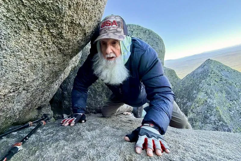 dale-sanders-91-crawls-between-rocks-while-climbing-mt-katahdin